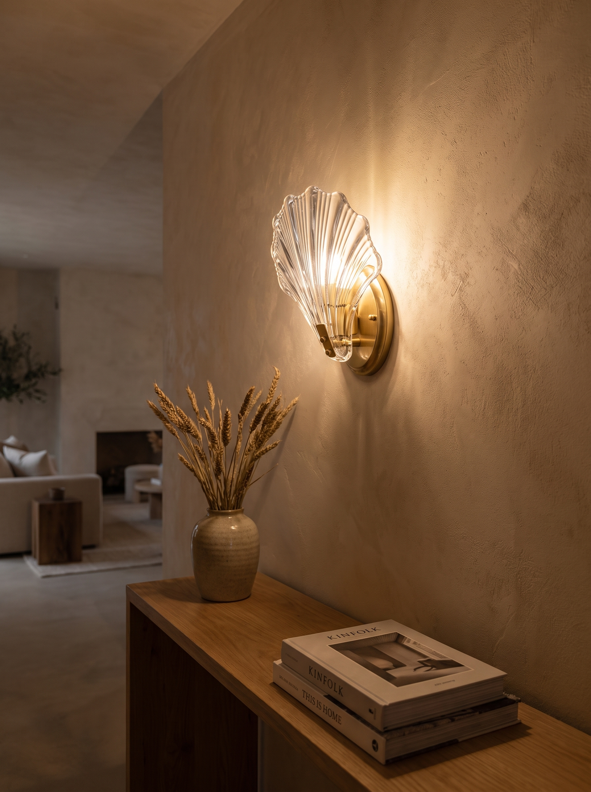 Shell Glass Wall Sconce glowing above a hallway console